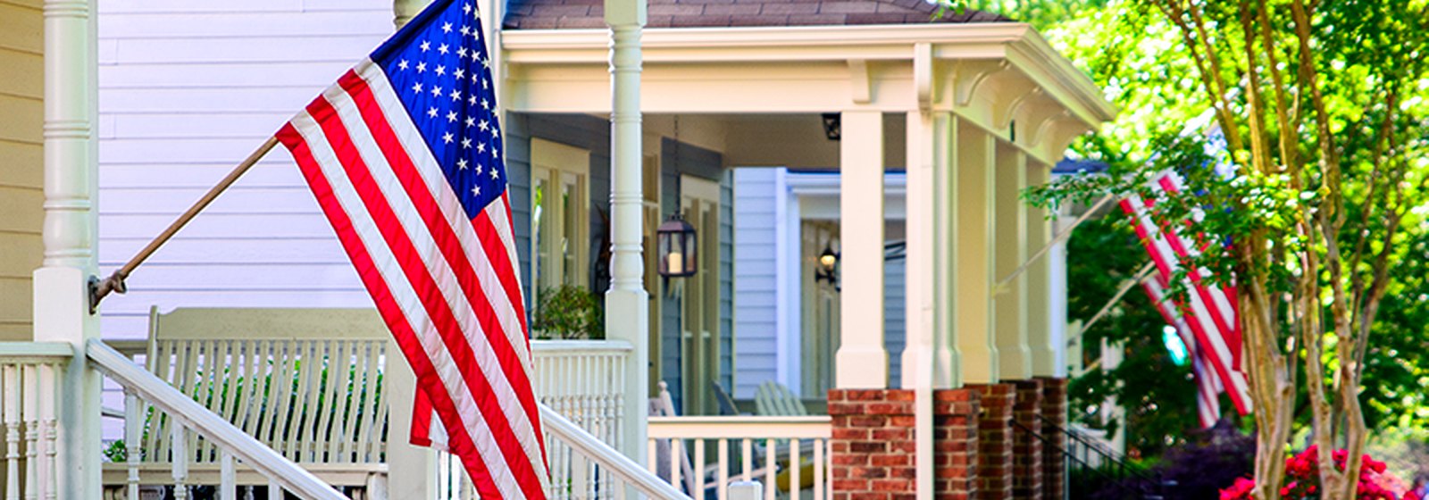 American flags on a small-town porch